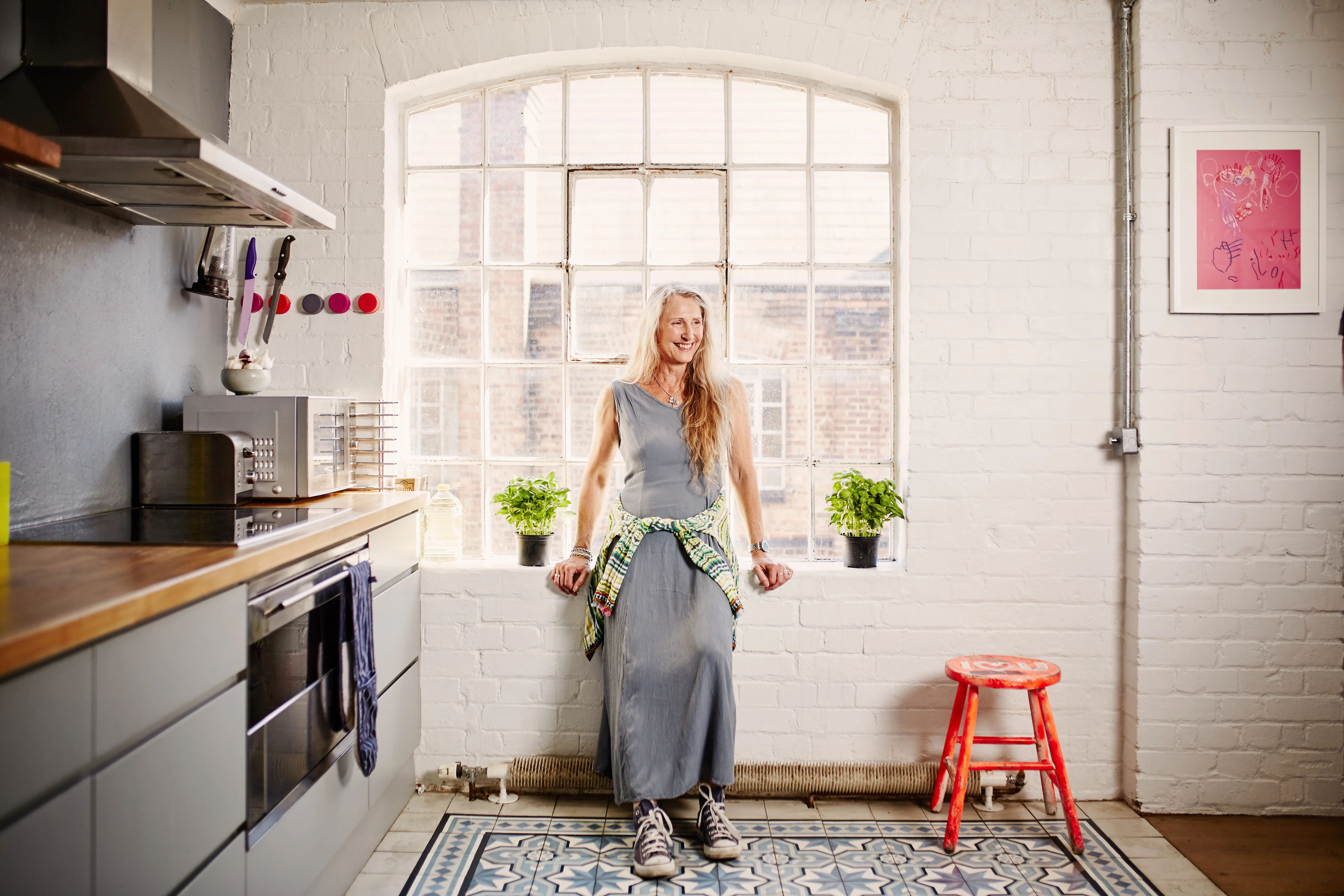 woman in grey dress in her kitchen